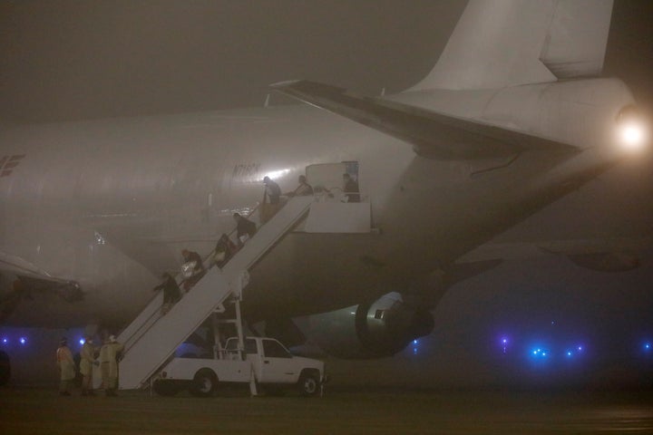 Additional passengers from the Diamond Princess cruise ship are seen arriving in the U.S. on Monday. The ship is believed to have had the highest concentration of coronavirus cases outside of China, where the new outbreak began.