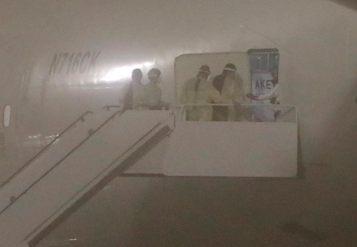 Officials board the Kalitta Air flight carrying American evacuees from the Diamond Princess cruise ship at Joint Base San Ant