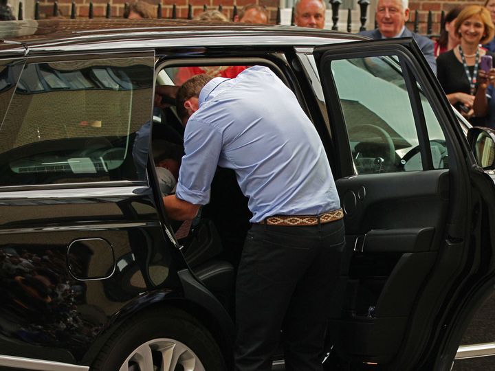 William putting George in the car seat, just as they'd practiced. 