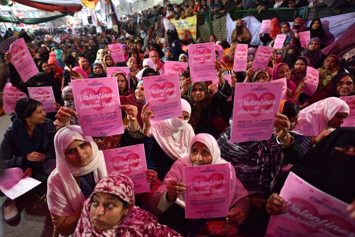 Women hold Valentines Day placards during a sit in protest against CAA, NRC and NPR at Shaheen Bagh on February 13, 2020. They have appealed to Prime Minister Narendra Modi to come and talk to them.