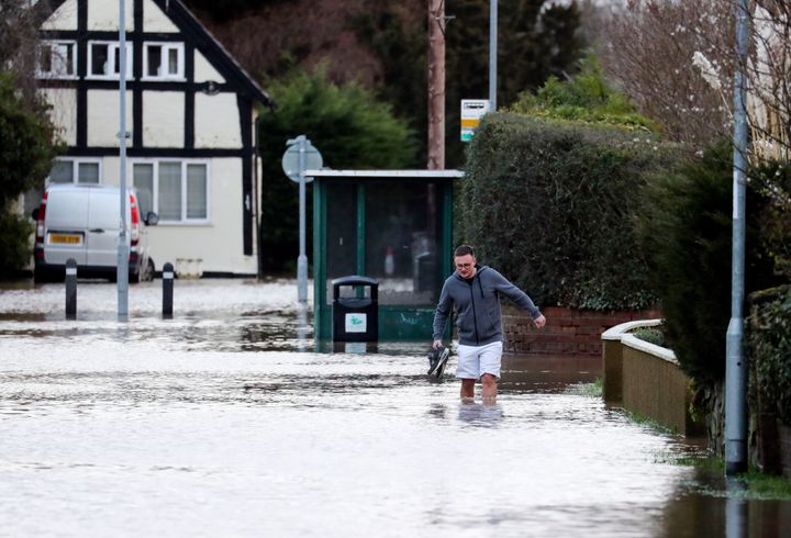 A man wades through flood water in Hereford.