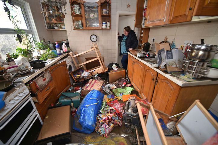 Rachel Cox inspecting flood damage in her kitchen in Nantgarw, south Wales.