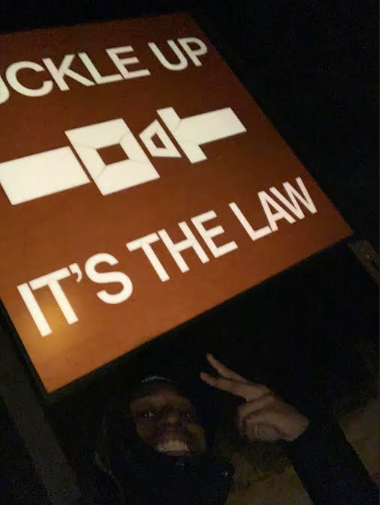 Jaylan Butler posed with a road sign near a rest stop in East Moline, Illinois, moments before police forced him to the ground and threatened to shoot him in the head, according to a lawsuit.