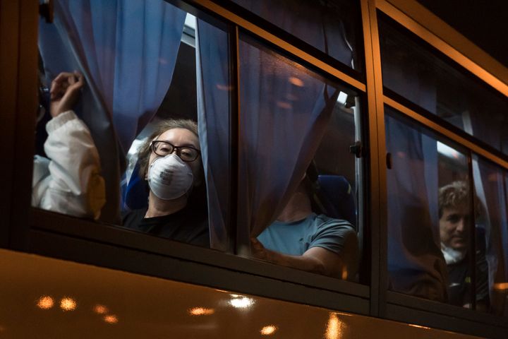Evacuees look out from a bus as they arrive at Haneda airport on February 17, 2020 in Tokyo, Japan. (Photo by Tomohiro Ohsumi/Getty Images)