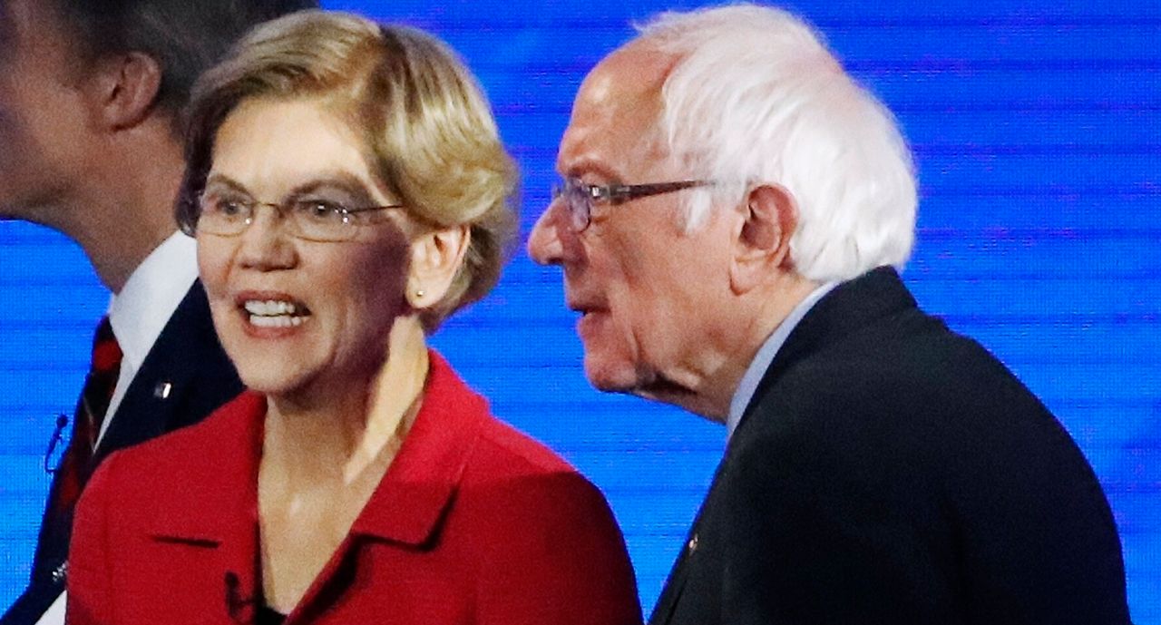 Sen. Elizabeth Warren (D-Mass.) and Sen. Bernie Sanders (I-Vt.) leave the stage after a Democratic presidential primary debate in New Hampshire on Feb. 7. Her talk of carefully reforming U.S. foreign policy is being compared to Sanders's more combative rhetoric.