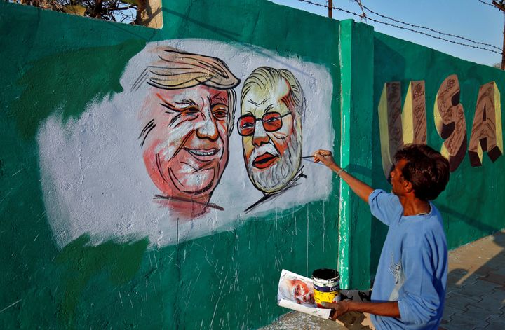 Paintings of US President Donald Trump and Prime Minister Narendra Modi on a wall as part of a beautification, along a route that Trump and Modi will be taking during Trump's upcoming visit, in Ahmedabad, India.