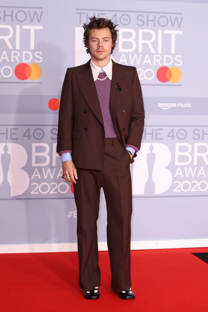 Harry posing on the Brit Awards red carpet