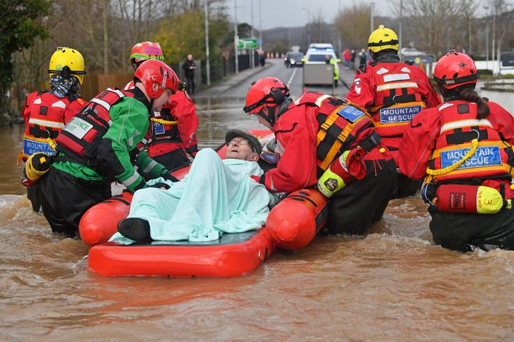 Mountain Rescue team members rescue Peter Morgan from his house where he has lived his whole life, which has been flooded in Monmouth.