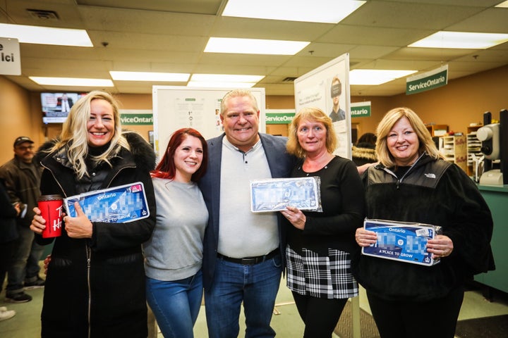 Ontario Minister Lisa Thompson, right, showcases her government's redesigned licence plate with Premier Doug Ford, centre, and MPP Kinga Surma, left.