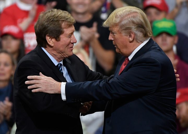 President Donald Trump greets then-Rep. Jason Lewis (R-Minn.) at a campaign rally on Oct. 4, 2018.