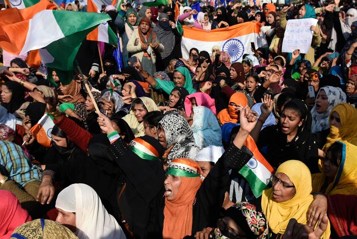 Protesters raise slogans ahead of their march to Home Minister Amit Shah's residence, at Shaheen Bagh, on February 16, 2020 in New Delhi.