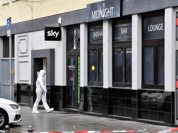 A forensic officer walks into the hookah bar where several people were killed late Wednesday in Hanau, Germany. Turkish