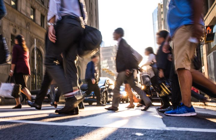 In this stock photo, pedestrians cross a busy street in downtown Toronto. Canadians have serious doubts about their financial future and the economy as a whole, a new survey from Edelman has found.