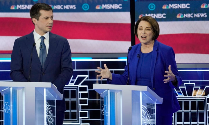 Senator Amy Klobuchar speaks as former South Bend Mayor Pete Buttigieg listens at the ninth Democratic 2020 U.S. Presidential candidates debate at the Paris Theater in Las Vegas, Nevada, U.S., February 19, 2020. REUTERS/Mike Blake