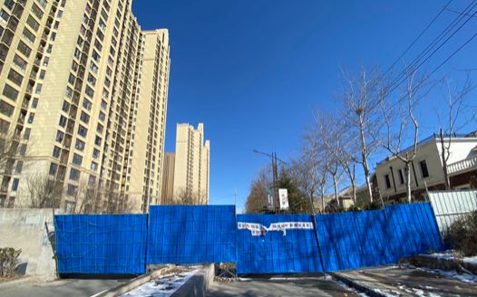 A wall that was recently put up to block a side street in the authors' neighborhood.