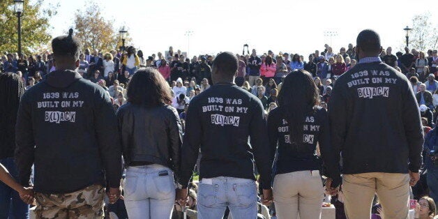 Members of Concerned Student 1950 join hands at a press conference at Traditions Plaza at Carnahan Quad, on the University of