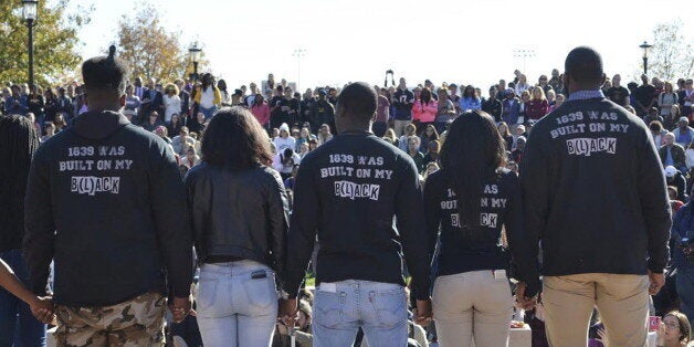 Members of Concerned Student 1950 join hands at a press conference at Traditions Plaza at Carnahan Quad, on the University of Missouri campus in Columbia, Missouri, November 9, 2015. University of Missouri's President Tim Wolfe's high-profile resignation was the latest shock to the state of Missouri, and the United States at large, which has been roiled for more than a year by racial tensions after police shot and killed an unarmed young black man in the state. REUTERS/The Maneater/Elizabeth LoutfiFOR EDITORIAL USE ONLY. NO RESALES. NO ARCHIVE.