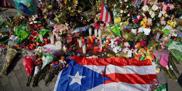 ORLANDO, FL - JUNE 15: A Puerto Rican flag is left at a makeshift memorial near Orlando Regional Medical Center, down the street from the crime scene at Pulse Nightclub, June 15, 2016 in Orlando, Florida. The shooting at Pulse Nightclub, which killed 49 people and injured 53, is the worst mass-shooting event in American history. (Photo by Drew Angerer/Getty Images)