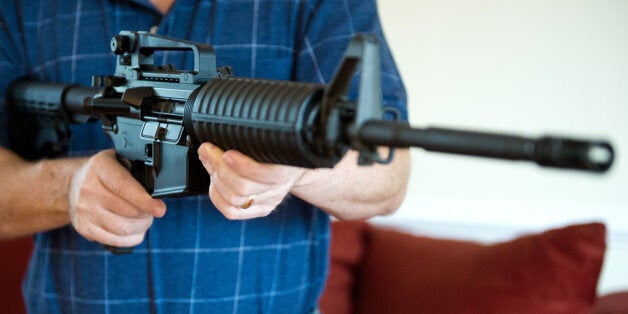 This February 4, 2013 photo illustration in Manassas, Virginia, shows a man holding a Colt AR-15 semi-automatic rifle. US President Barack Obama Monday heaped pressure on Congress for action 'soon' on curbing gun violence. Obama made a pragmatic case for legislation on the contentious issue, arguing that just because political leaders could not save every life, they should at least try to save some victims of rampant gun crime. AFP PHOTO/Karen BLEIER (Photo credit should read KAREN BLEIER/AFP/Getty Images)