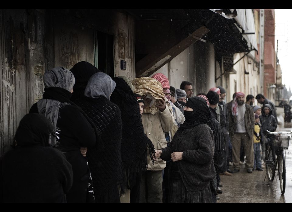 Syrians queue for bread outside a bakery