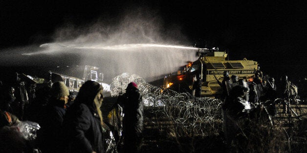 Police use a water cannon on protesters during a protest against plans to pass the Dakota Access pipeline near the Standing R