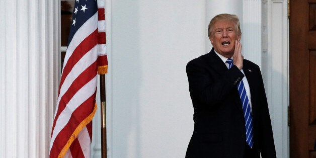 U.S. President-elect Donald Trump yells to members of the media from the steps of the main clubhouse at Trump National Golf C