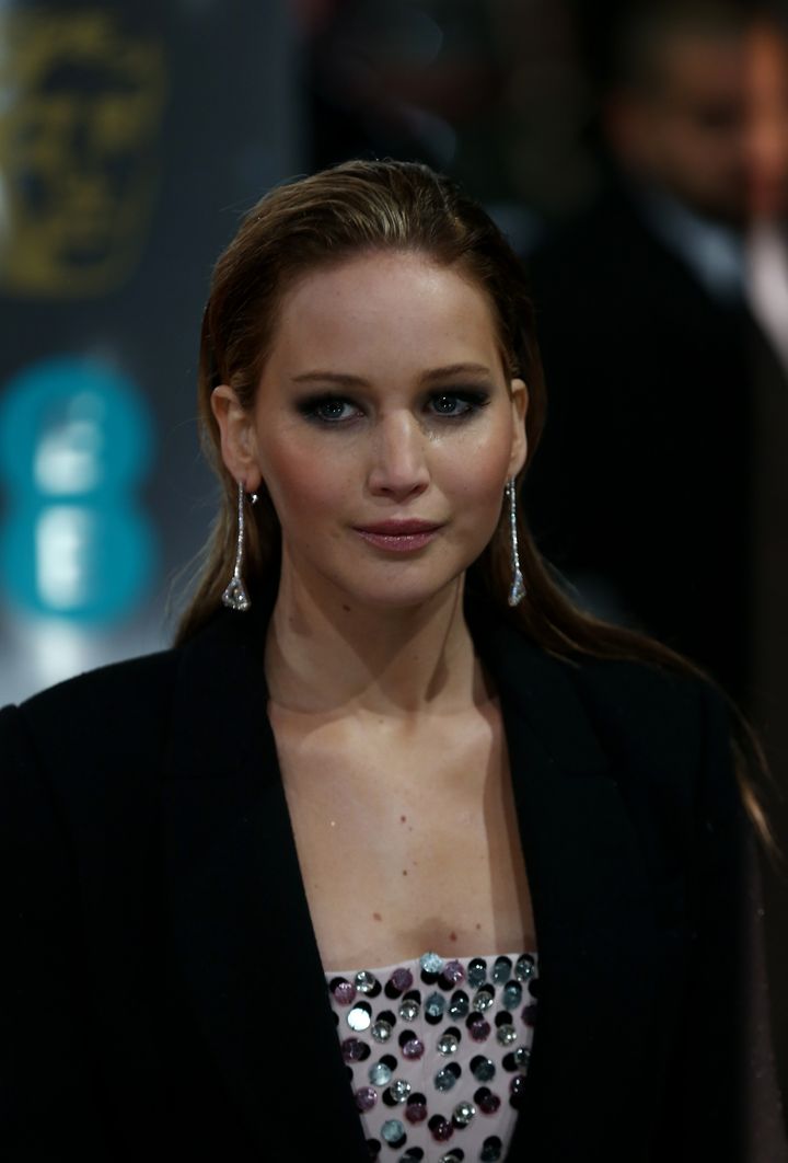 US actress Jennifer Lawrence poses for photographs on the red carpet as she arrives for the BAFTA British Academy Film Awards at the Royal Opera House in London on February 10, 2013. AFP PHOTO/Andrew COWIE (Photo credit should read ANDREW COWIE/AFP/Getty Images)