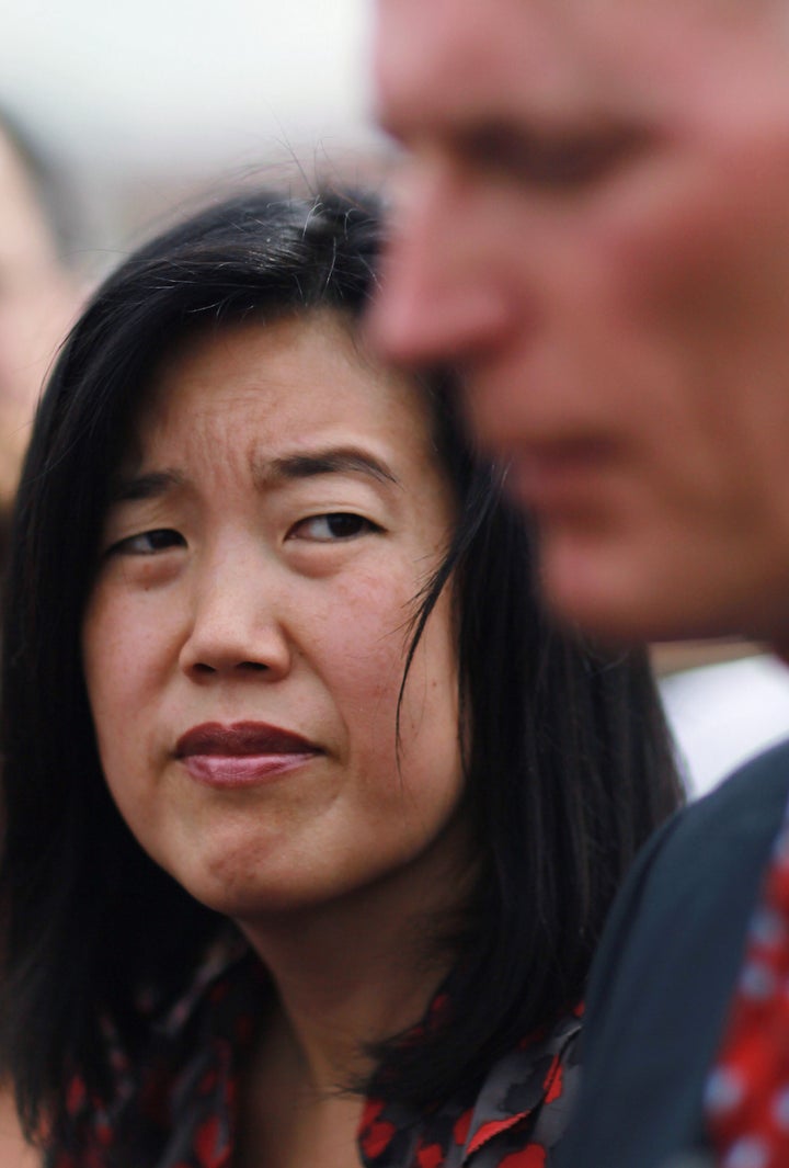 OPA LOCKA, FL - JANUARY 06: Michelle Rhee, who was named as the Informal Education Advisor to the Governor, listens as Florida Florida Governor Rick Scott (R) speaks to the media during a visit to the Florida International Academy charter school on January 6, 2011 in Opa Locka, Florida. Gov. Scott announced yesterday that Rhee, who is the former head of public schools in Washington, D.C., will now serve the governor as the Informal Education Advisor to the Governor. (Photo by Joe Raedle/Getty Images)