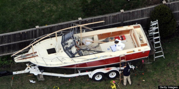 WATERTOWN, MA - APRIL 20: Investigators work around the boat where Dzhokhar A. Tsarnaev was found hiding after a massive manhunt, in the backyard of a Franklin Street home, in an aerial view April 20, 2013 in Watertown, Massachusetts. A manhunt for Dzhokhar A. Tsarnaev, 19, a suspect in the Boston Marathon bombing ended after he was apprehended on a boat parked on a residential property in Watertown, Massachusetts. His brother Tamerlan Tsarnaev, 26, the other suspect, was shot and killed after a car chase and shootout with police. The bombing, on April 15 at the finish line of the marathon, killed three people and wounded at least 170. (Photo by Darren McCollester/Getty Images)