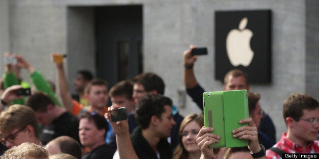 BERLIN, GERMANY - MAY 03: Apple enthusiasts wait in line before entering the new Apple Store on Kurfuerstendamm avenue on its opening day on May 3, 2013 in Berlin, Germany. Thousands of people waited to enter the store, which is Apple's first in Berlin and its biggest in Germany. (Photo by Sean Gallup/Getty Images)