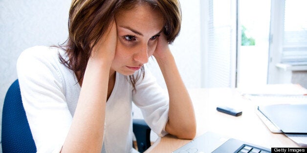 Woman thinks to notebook