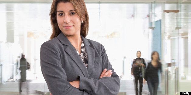 Hispanic businesswoman standing in office