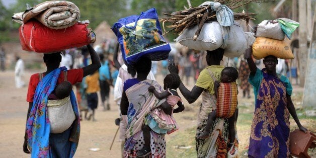 Displaced South Sudanese women walk towards the United Nations Mission in South Sudan (UNMISS) base in Malakal on January 12, 2014. About 32,000 refugees have fled to Uganda and a total of around 10,000 others have gone to Ethiopia and Kenya, while more than 350,000 are internally displaced within South Sudan, the United Nations says. AFP PHOTO/SIMON MAINA (Photo credit should read SIMON MAINA/AFP/Getty Images)