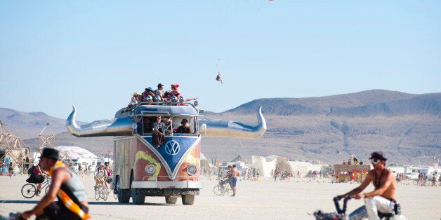 BLACK ROCK CITY, NV - SEPT 2: Like a scene from the World's Fairs of yesteryear, 2011 Burning Man participants intermingle with an oversized VW Van art car, balloon paraglider, and a thriving bicycle community. (Photo by Keith Carlsen For the Washington Post)