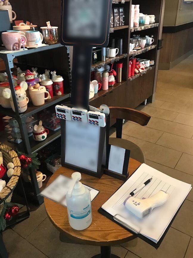 A table set up near the door at a Starbucks, where customers’ temperatures were taken before they were able to pick up their coffees.