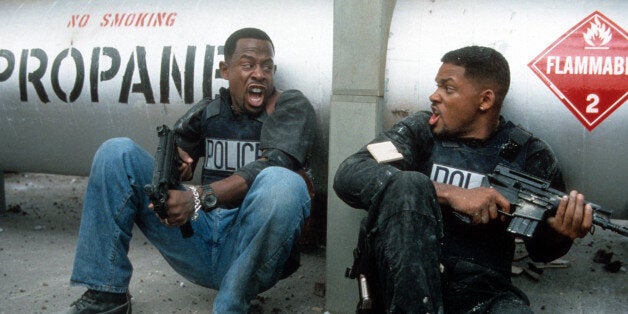 Martin Lawrence and Will Smith yelling at each other while holding machine guns to defend themselves in a scene from the film 'Bad Boys', 1995. (Photo by Columbia Pictures/Getty Images)