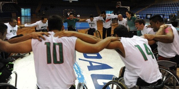 Mexican's basketball wheelchair players celebrate after winning the First Central America, Mexico and the Caribbean Basketball wheelchair tournament match against Venezuela in Guatemala city on November 6, 2014. AFP PHOTO Johan ORDONEZ (Photo credit should read JOHAN ORDONEZ/AFP/Getty Images)