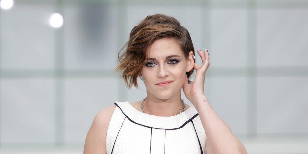 Actress Kristen Stewart poses for photographers as she arrives for Chanel 's Spring-Summer 2015 Haute Couture fashion collec