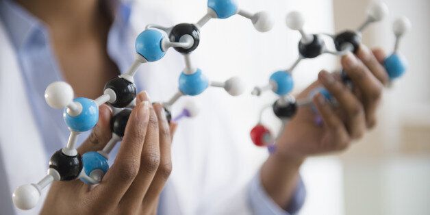 Mixed race scientist examining molecular model