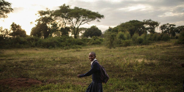 A Tanzanian girl smiles as she makes her way back from school in Arusha, eastern Tanzania, Thursday, Jan. 15, 2015. The city is close to national parks including Serengeti and Kilimanjaro. (AP Photo/Mosa'ab Elshamy)