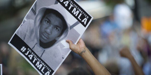 Demonstrators march in Beverly Hills on July 17, 2013 to protest the acquittal of George Zimmerman in the killing of Florida teen Trayvon Martin. It is the fourth day of protests in Los Angeles and other major US cities since Zimmerman, a neighborhood watch volunteer, was acquitted in the February 2012 shooting death of 17-year-old Martin. AFP PHOTO / ROBYN BECK (Photo credit should read ROBYN BECK/AFP/Getty Images)