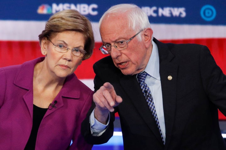 Sen. Elizabeth Warren and Sen. Bernie Sanders talk during a Democratic presidential primary debate on Feb. 19, 2020.