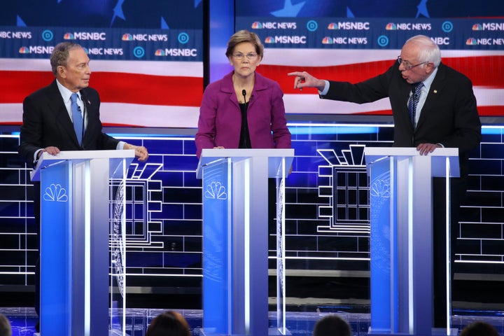 Sen. Bernie Sanders gestures at former New York City Mayor Mike Bloomberg as Sen. Elizabeth Warren listens during the De