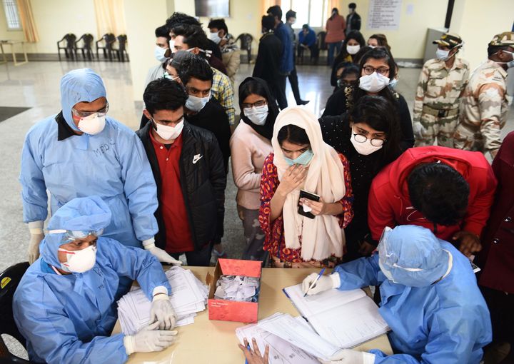 Indians who were air-lifted from Wuhan following out-break of the deadly novel cornavirus, wait to collect release certificates before leaving from the ITBP quarantine facility, at Chhawla, near Nazafgarh on February 17, 2020 in New Delhi.