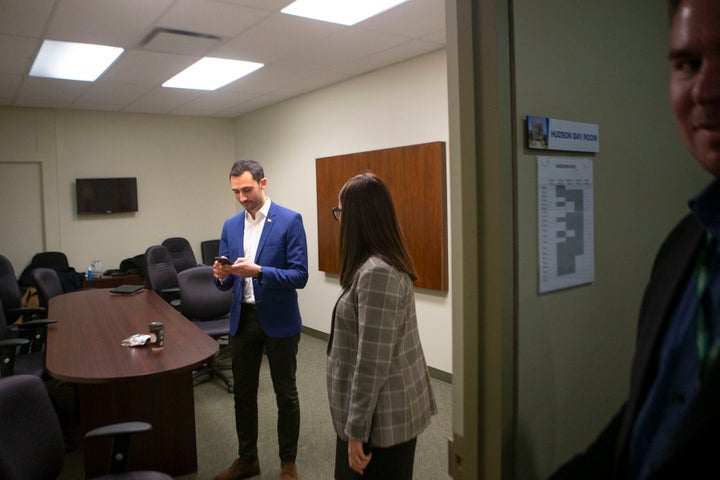 Ontario Education Minister Stephen Lecce is pictured in a Progressive Conservative caucus office as protesters gather outside Queen's Park in Toronto on Feb. 21, 2020.