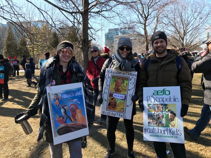 Demonstrators show off their signs about Ontario Premier Doug Ford at a protest organizes by teachers' unions on Feb. 21, 2020.