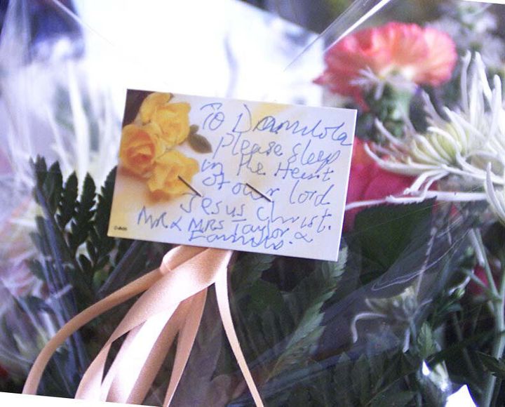 Flowers from the parents, Richard and Gloria Taylor, of murdered 10-year-old Damilola, left while visiting the spot where their son was killed in Peckham. Police hunting the killers of the 10-year-old arrested two youths and a woman in connection with the murder. Detective Superintendent David Dillnutt told a press conference at New Scotland Yard that the arrests were made at 6am at addresses in Southwark, south east London. See PA News story POLICE Boy. PA photo: Sean Dempsey