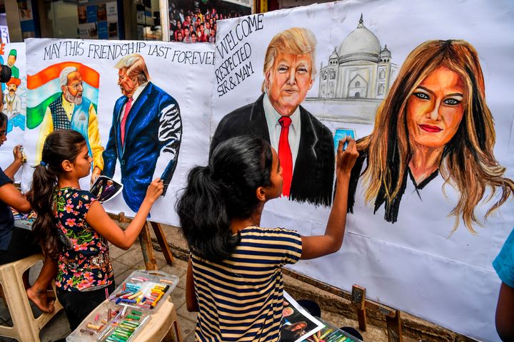 TOPSHOT - Students paint on canvas faces of US President Donald Trump (C), his wife Melania (R), and India's Prime Minister Narendra Modi (L) in the street in Mumbai on February 21, 2020, ahead of the visit of US President in India. (Photo by INDRANIL MUKHERJEE / AFP) (Photo by INDRANIL MUKHERJEE/AFP via Getty Images)