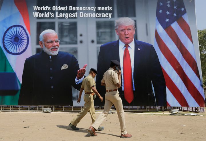Indian policemen walks past a hoarding welcoming U.S President Donald Trump, at the airport ahead of his visit in Ahmedabad, India, Saturday, Feb. 22, 2020. 