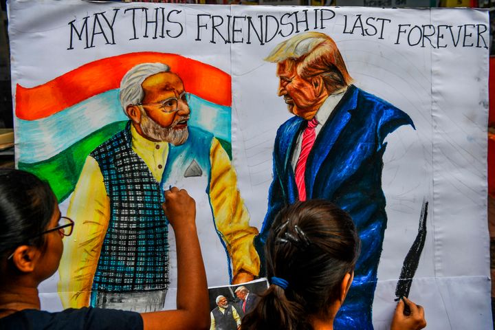 Students paint on canvas faces of US President Donald Trump and India's Prime Minister Narendra Modi in Mumbai on February 21, 2020, ahead of his visit to India. 